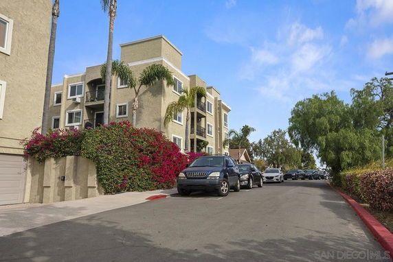 Front view of a multi-story apartment building with balconies.