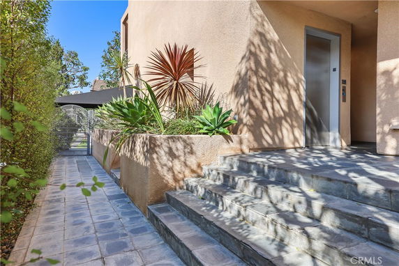 Front view of a building with steps and an elevator entrance.