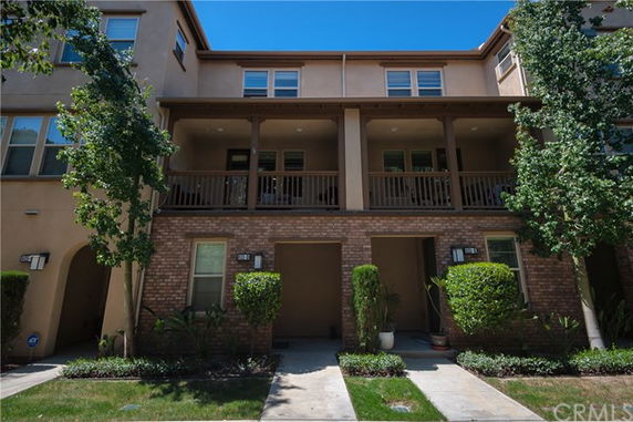 Front view of a multi-story residential building with balconies.