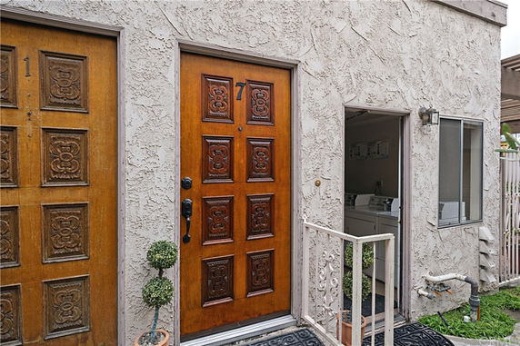 Front view of a building entrance with decorative wooden doors.