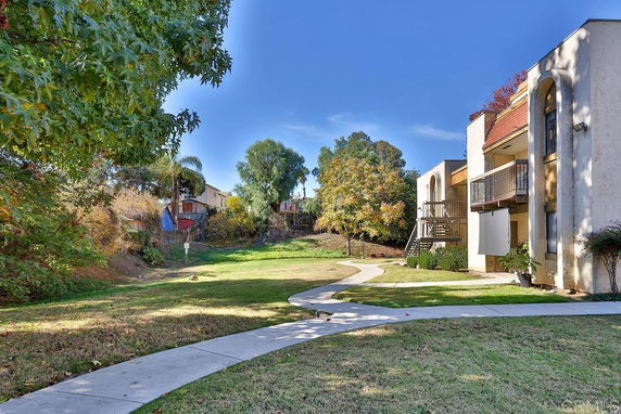 Outdoor view of a residential area with apartment buildings and pathways.
