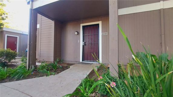 Front view of a single-story building entrance with a door and small porch.