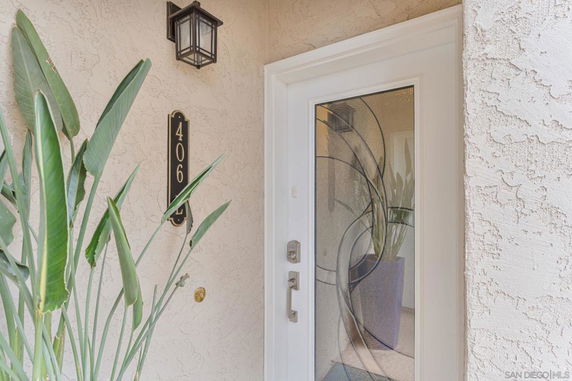 Front view of an entrance door with decorative glass and house number 406.