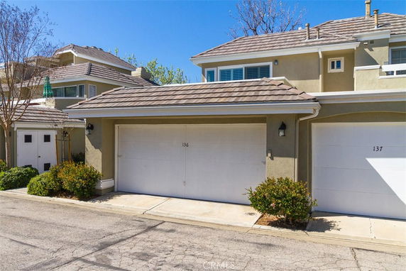 Front view of a house with a double garage and tiled roof.