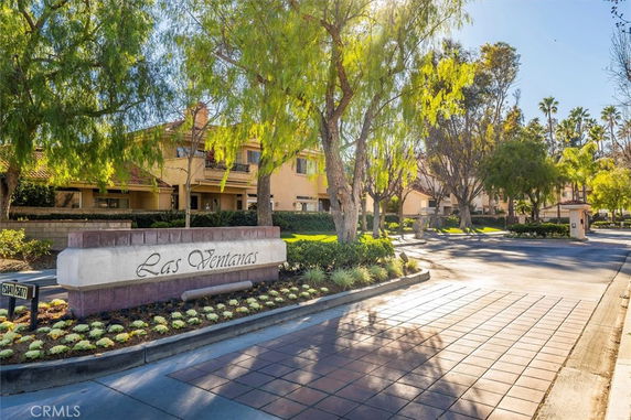 Front view of a residential complex with trees and a sign that reads 'Las Ventanas.'