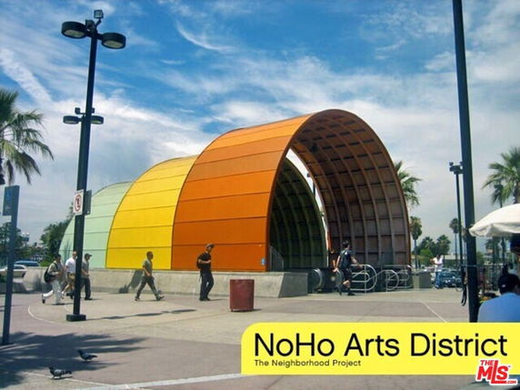 Front view of a colorful arched structure in an outdoor setting.