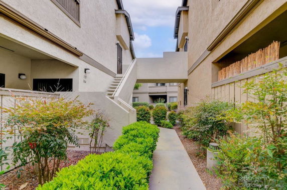 View of residential building exterior with walkway and stairs.