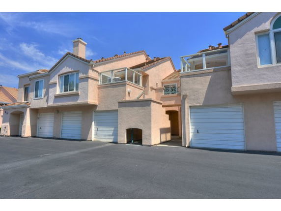 Front view of multi-story residential buildings with garages.