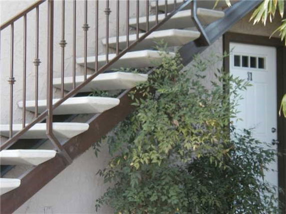 Side view of an exterior staircase leading to a door.
