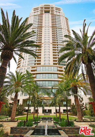 Front view of a tall, modern high-rise building with multiple balconies.