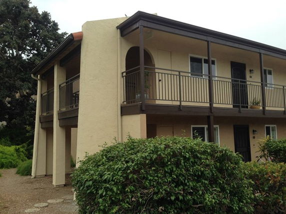 Front view of a two-story building with balconies.