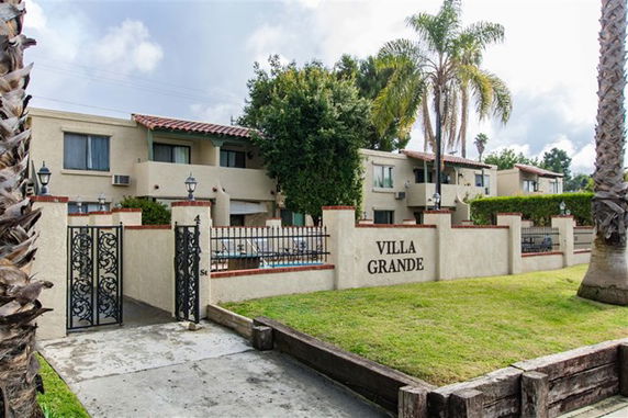 Front view of a two-story building with gated entrance named Villa Grande.