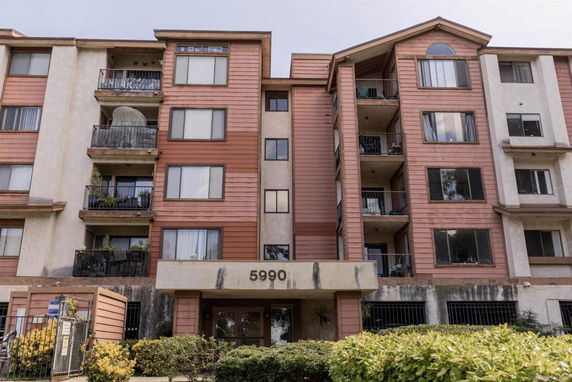 Front view of a multi-story residential building with balconies.