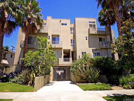 Front view of a multi-story residential building with balconies.