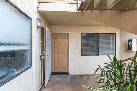 Front view of an apartment entrance with a door and window.