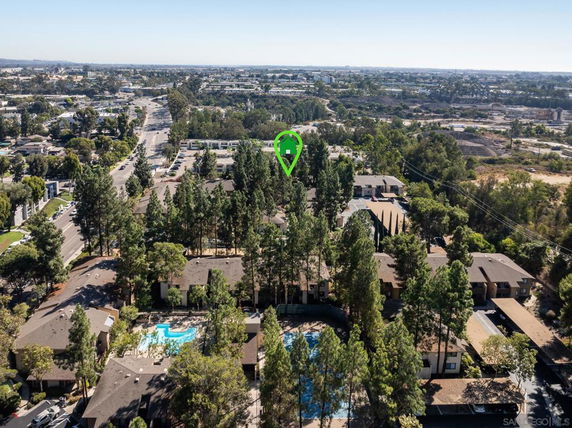 Aerial view of a residential area with multiple apartment buildings surrounded by trees.