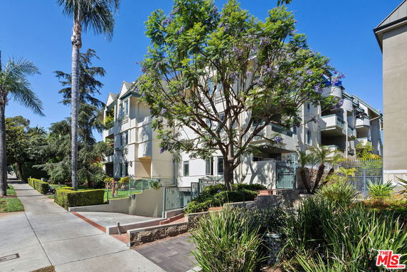 Front view of a multi-story residential building with balconies.