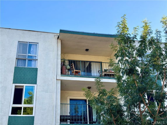 Front view of a multi-story residential building with balconies.