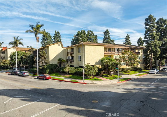 Front view of a multi-story apartment building on a corner lot
