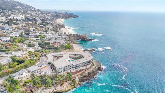Aerial view of a coastal area with buildings and rocky shorelines.