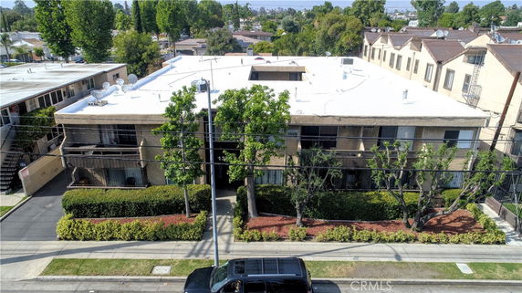 Front view of a residential building with multiple units and a flat roof.