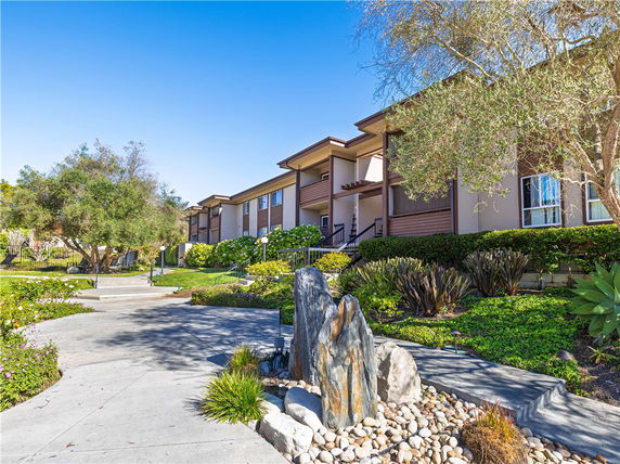 Front view of a two-story residential building with landscaped garden.