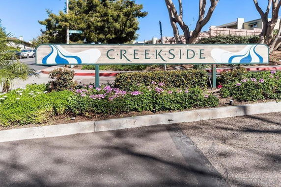 Entrance sign for Creekside with surrounding landscaping.