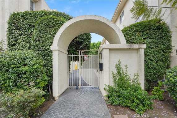 Front view of a building entrance with a gated archway.