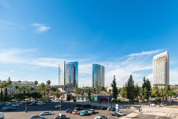 Skyline view of modern high-rise buildings with parking area in the foreground.