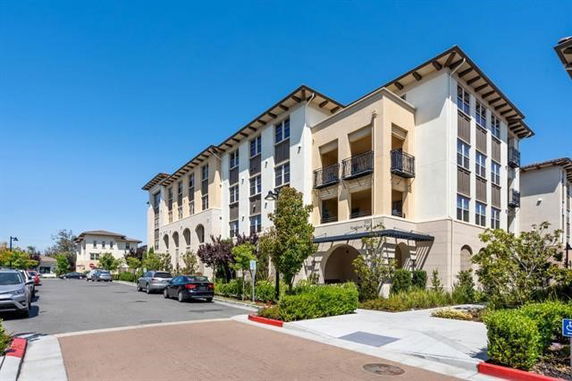 Front view of a multi-story building with balconies.