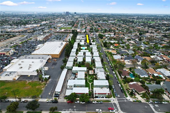 Panoramic aerial view of a residential area with multiple buildings and roads.