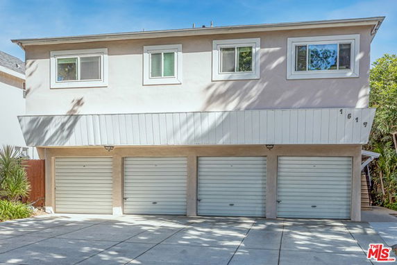 Front view of a two-story building with multiple garage doors on the ground floor.