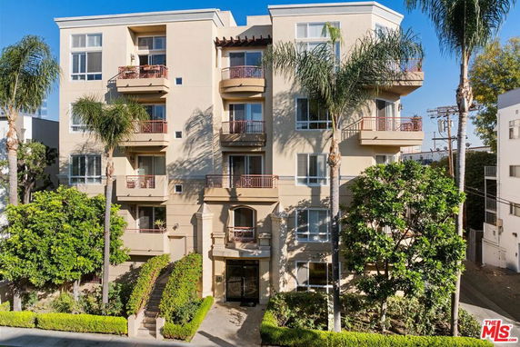 Front view of a multi-story apartment building with balconies.