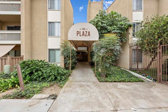 Front view of a multi-story apartment building with 'The Plaza' sign at the entrance.