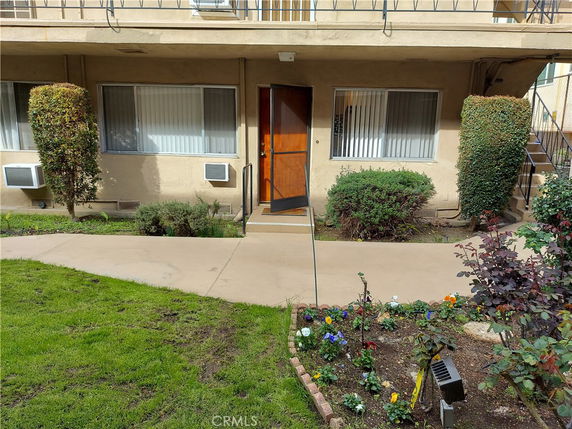 Front view of a building with multiple windows and a doorway.