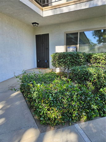 Front view of a building entrance with a metal security door.