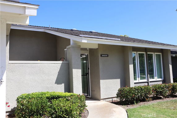 Front view of a single-story house with a flat roof and large windows.