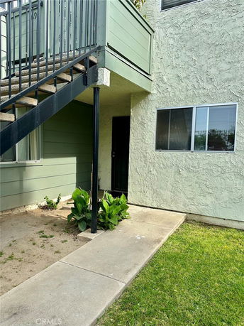 Front view of a building with stairs leading to an upper level.