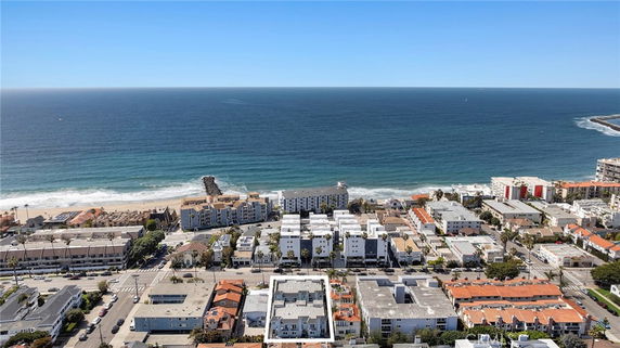 Aerial view of coastal buildings and the ocean.