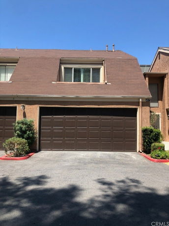Front view of a house with a sloped roof and double garage.