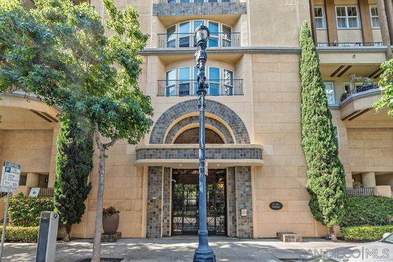 Front view of a multi-story building entrance with decorative arches.