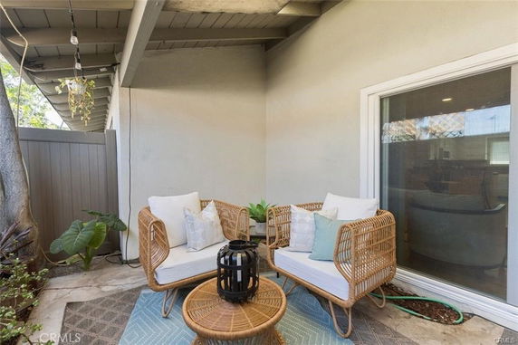 Outdoor patio area with wicker chairs and a small table.