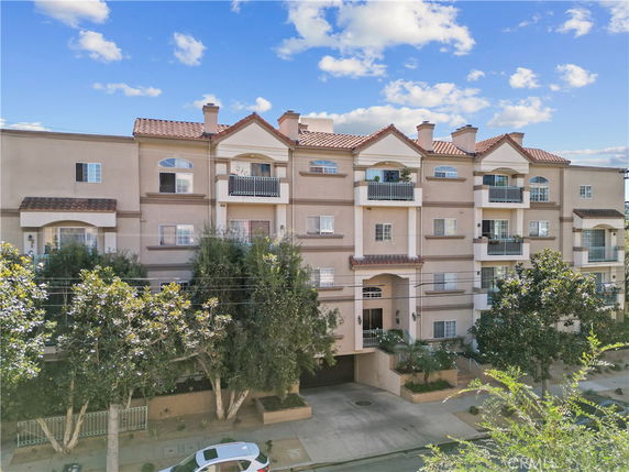 Front view of a multi-story residential building with balconies.