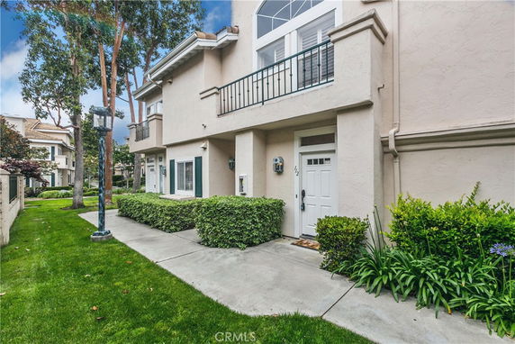 Front view of a multi-story house with a small balcony above the entrance.