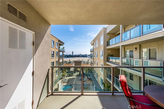 View from a balcony overlooking a courtyard and distant buildings.