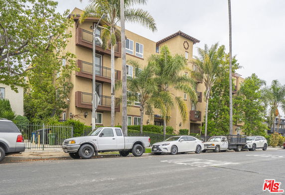 Front view of a multi-story apartment building with balconies.
