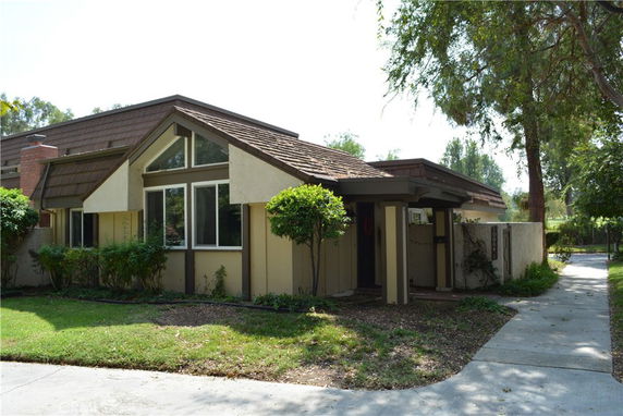 Front view of a single-story house with large windows and a sloped roof.