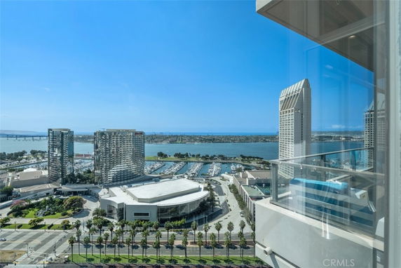 Wide-angle view of urban buildings, waterfront, and marina.