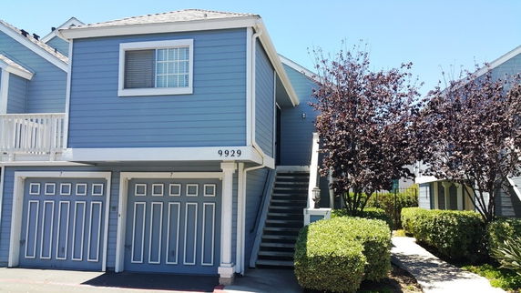 Front view of a two-story building with two garages.