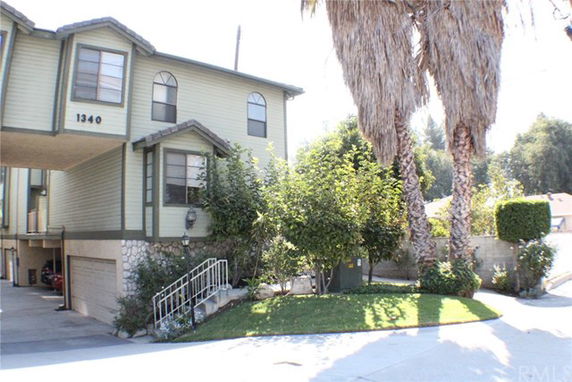 Front view of a two-story house with a covered parking area.
